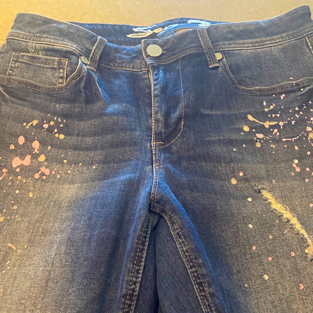 Jeans slightly distressed, pink accents, size 10